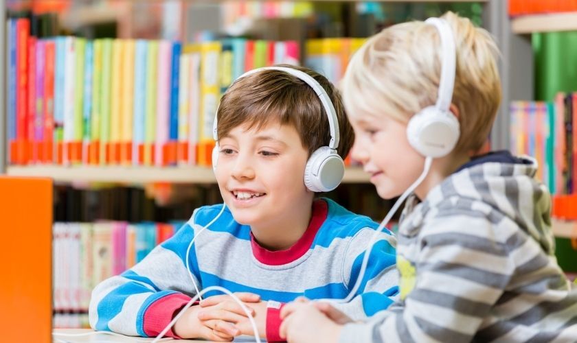 Two boys listening to podcasts